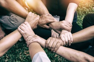 The abstract art design background of human hands touching together, United hands together, expressing positive, teamwork concept