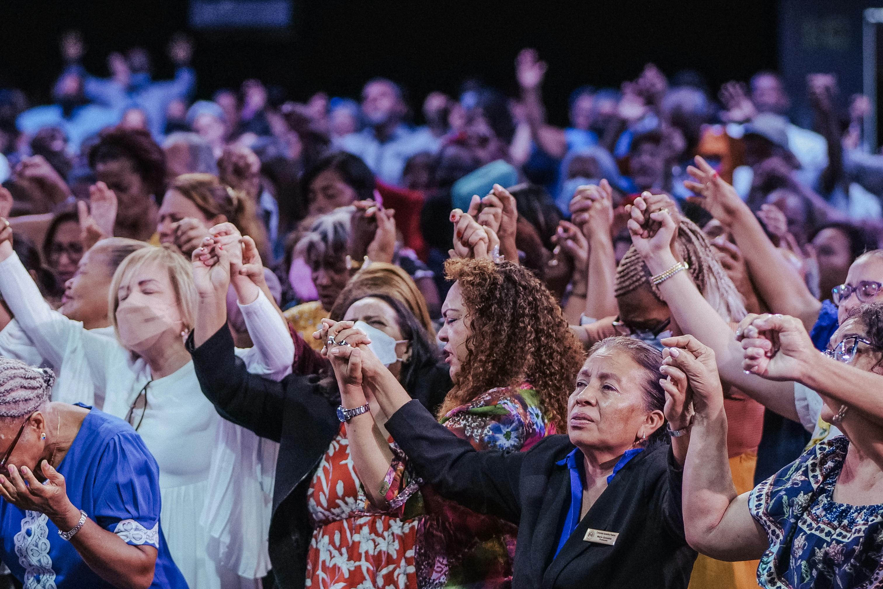 Photo by Luis Quintero: https://www.pexels.com/photo/people-holding-hands-during-religious-gathering-16102709/